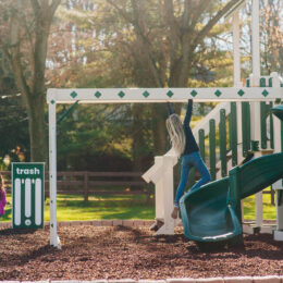 This image shows children playing on King Swings Commercial's Navigator Playground