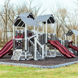 An ivory, black, and red commercial playground.