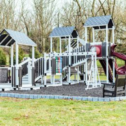 An ivory, black, and red commercial playground.