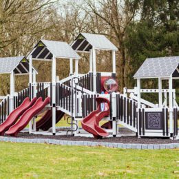 An ivory, black, and red commercial playground.