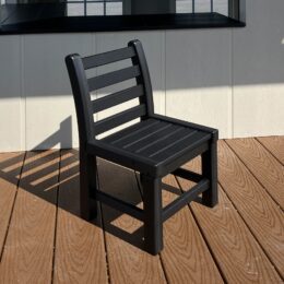 A black poly chair on a deck.